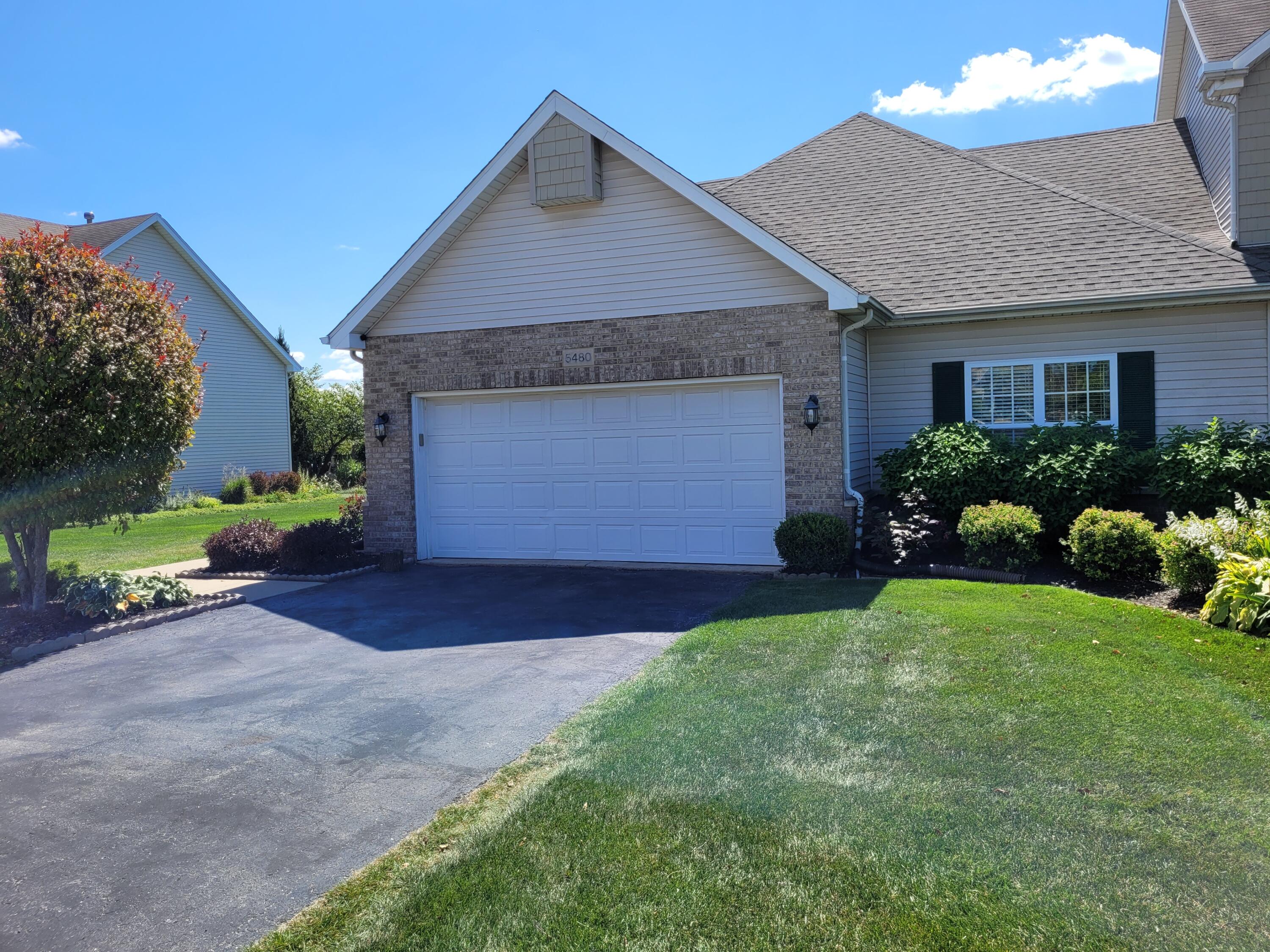 5480 Victoria Place Crown Point, IN 46307 - Photo 1 of 14 a front view of a house with a yard and garage