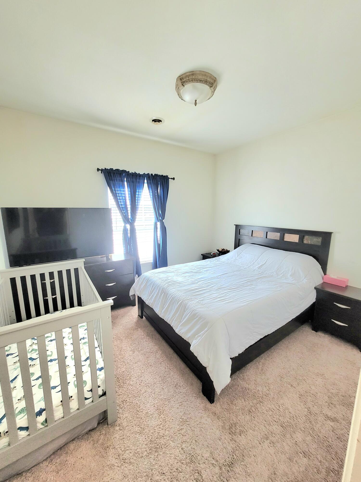 5480 Victoria Place Crown Point, IN 46307 - Photo 13 of 14 a bed sitting in a room next to a lamp