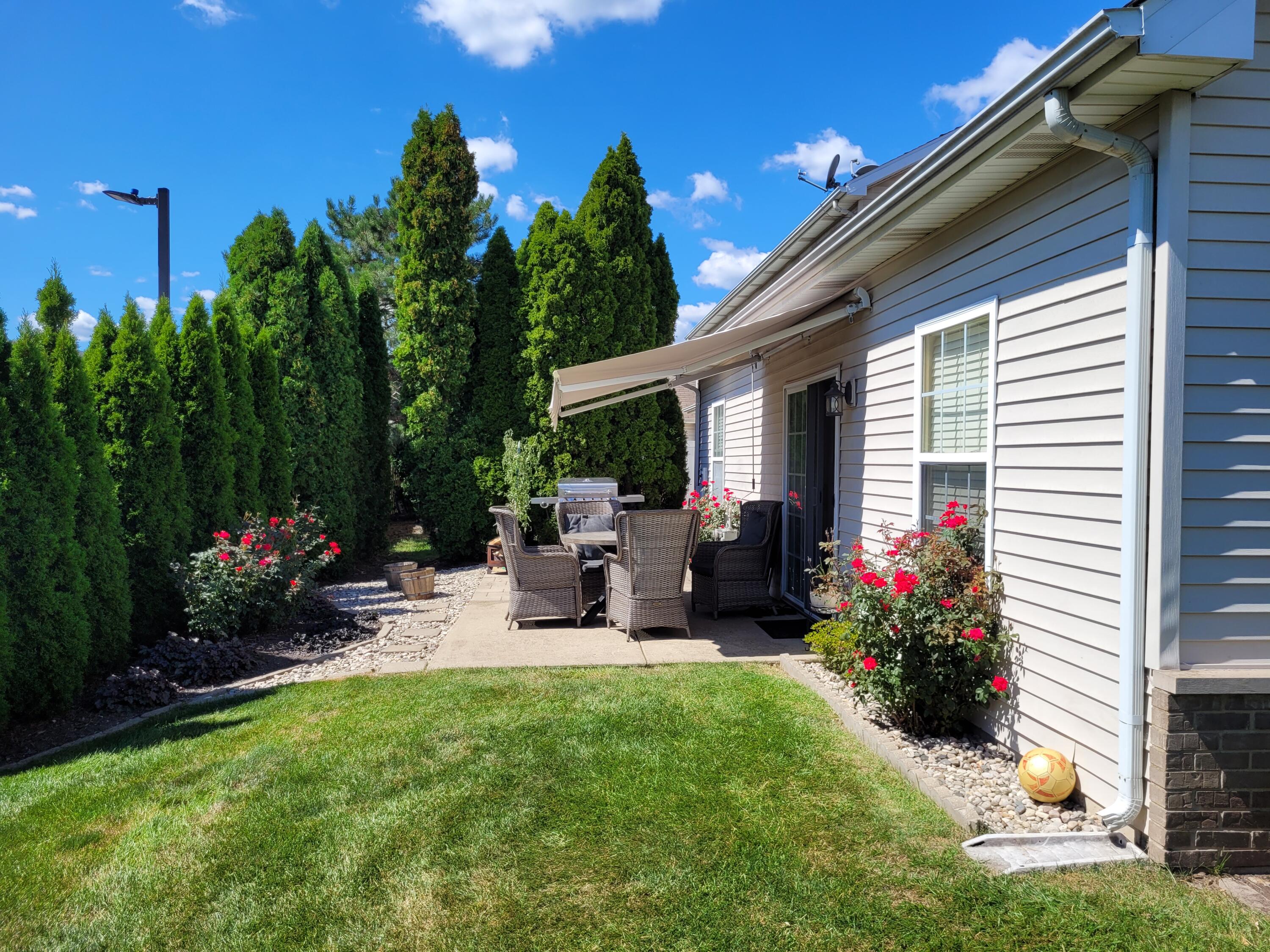 5480 Victoria Place Crown Point, IN 46307 - Photo 4 of 14 a view of a house with backyard sitting area and garden