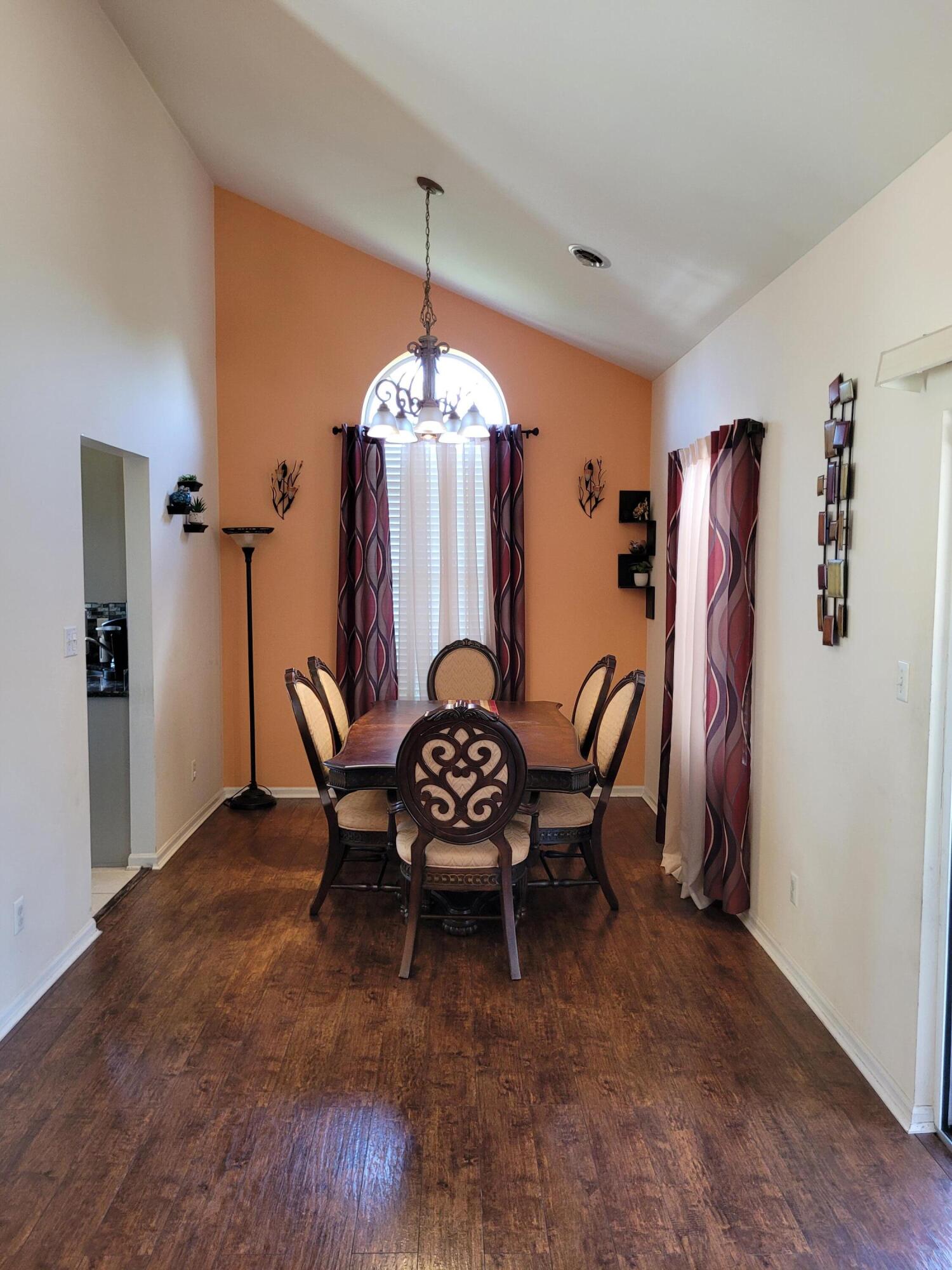 5480 Victoria Place Crown Point, IN 46307 - Photo 9 of 14 a dining room with furniture a chandelier and wooden floor