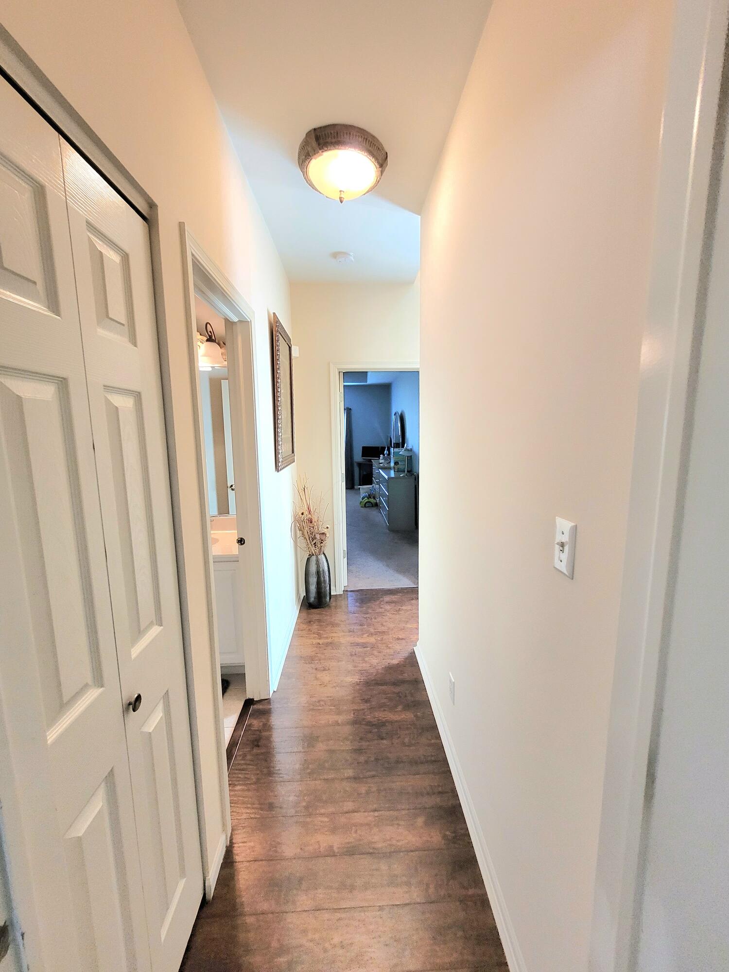 5480 Victoria Place Crown Point, IN 46307 - Photo 10 of 14 a view of a hallway with wooden floor and staircase