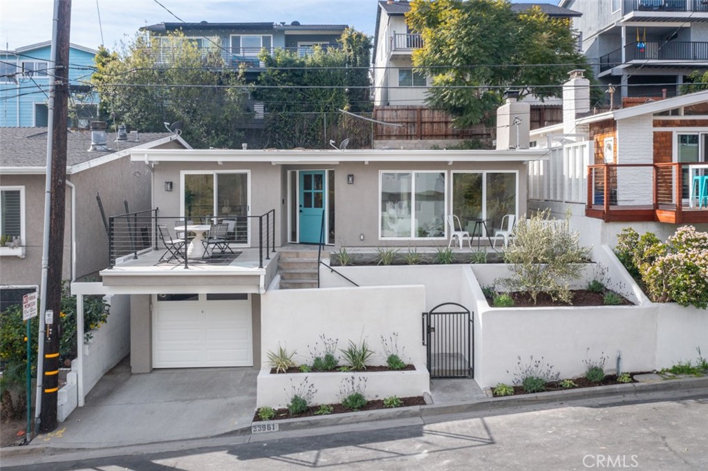 33961 Crystal Lantern Dana Point, CA 92629 - Photo 1 of 28 a front view of a house with a garden and plants