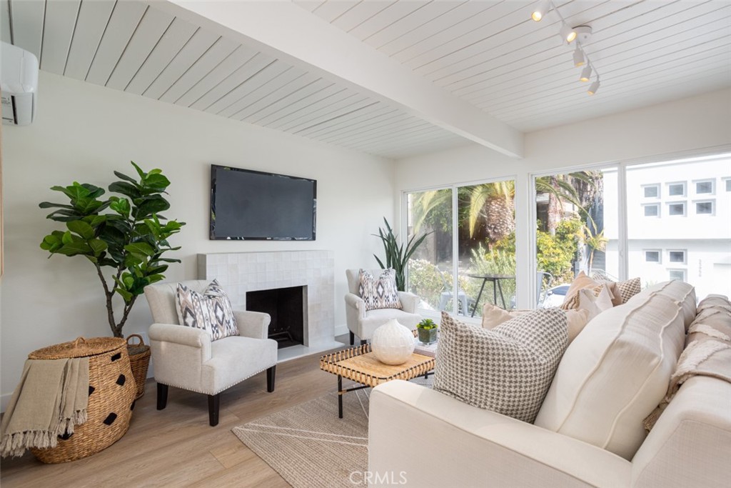 33961 Crystal Lantern Dana Point, CA 92629 - Photo 11 of 28 a living room with furniture a fireplace and a potted plant