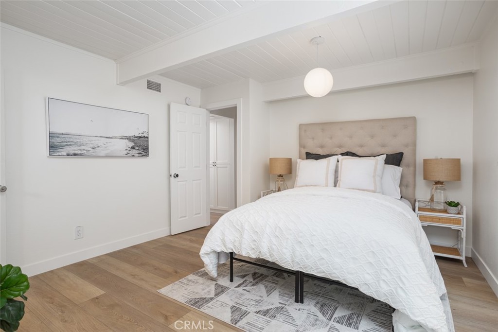 33961 Crystal Lantern Dana Point, CA 92629 - Photo 13 of 28 a bedroom with a bed and painting on the wall