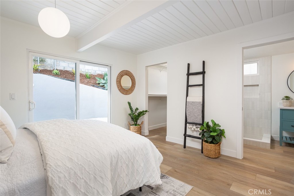 33961 Crystal Lantern Dana Point, CA 92629 - Photo 14 of 28 a bedroom with a bed and a potted plant