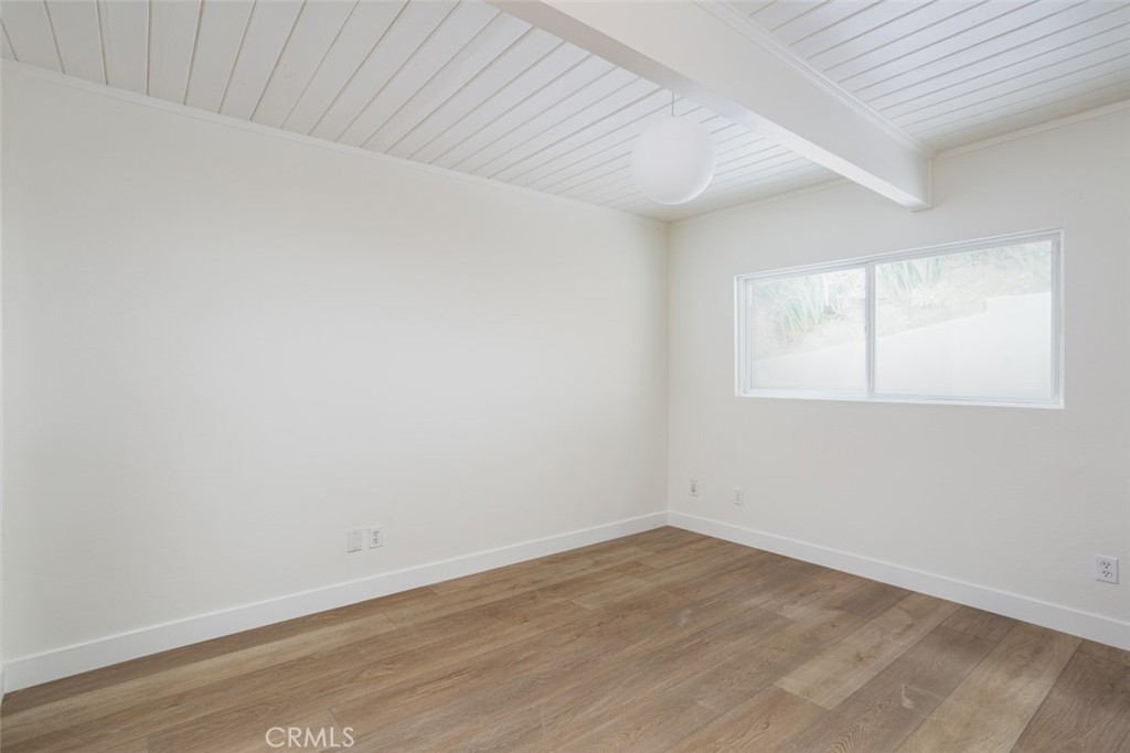 33961 Crystal Lantern Dana Point, CA 92629 - Photo 20 of 28 an empty room with wooden floor and windows