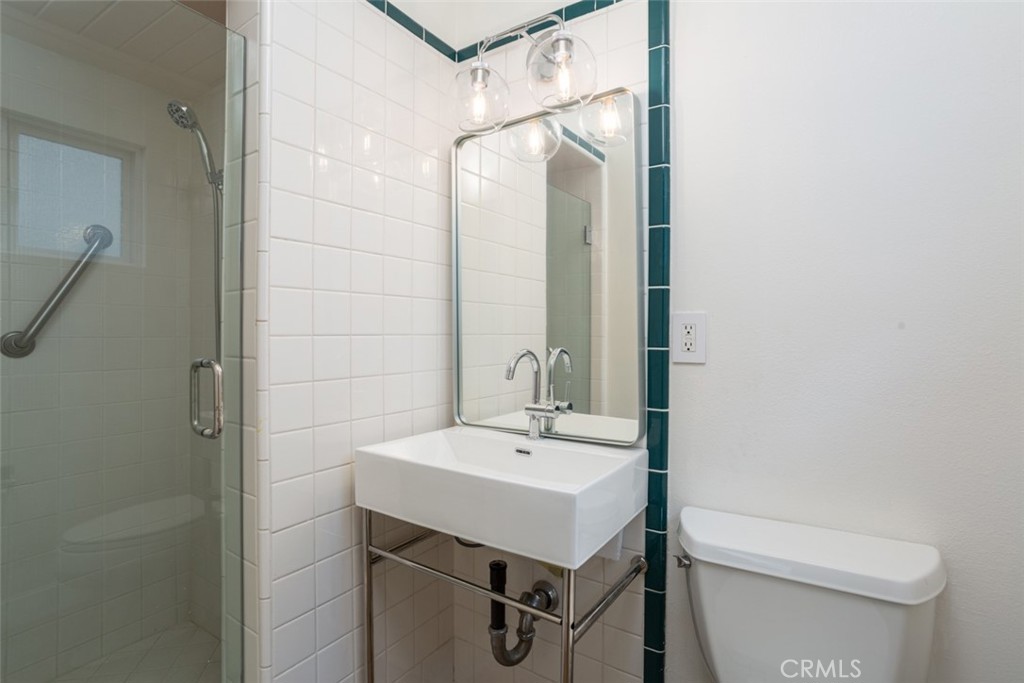 33961 Crystal Lantern Dana Point, CA 92629 - Photo 24 of 28 a bathroom with a sink a toilet and shower
