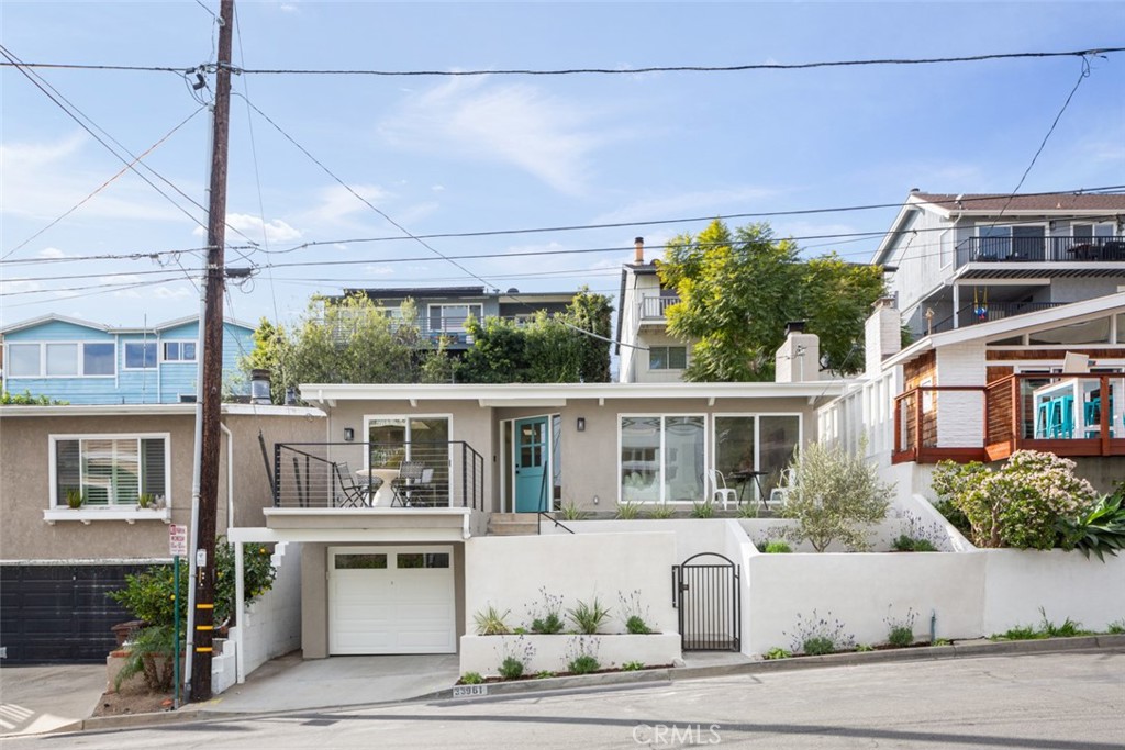 33961 Crystal Lantern Dana Point, CA 92629 - Photo 27 of 28 a front view of a building with a garden and plants