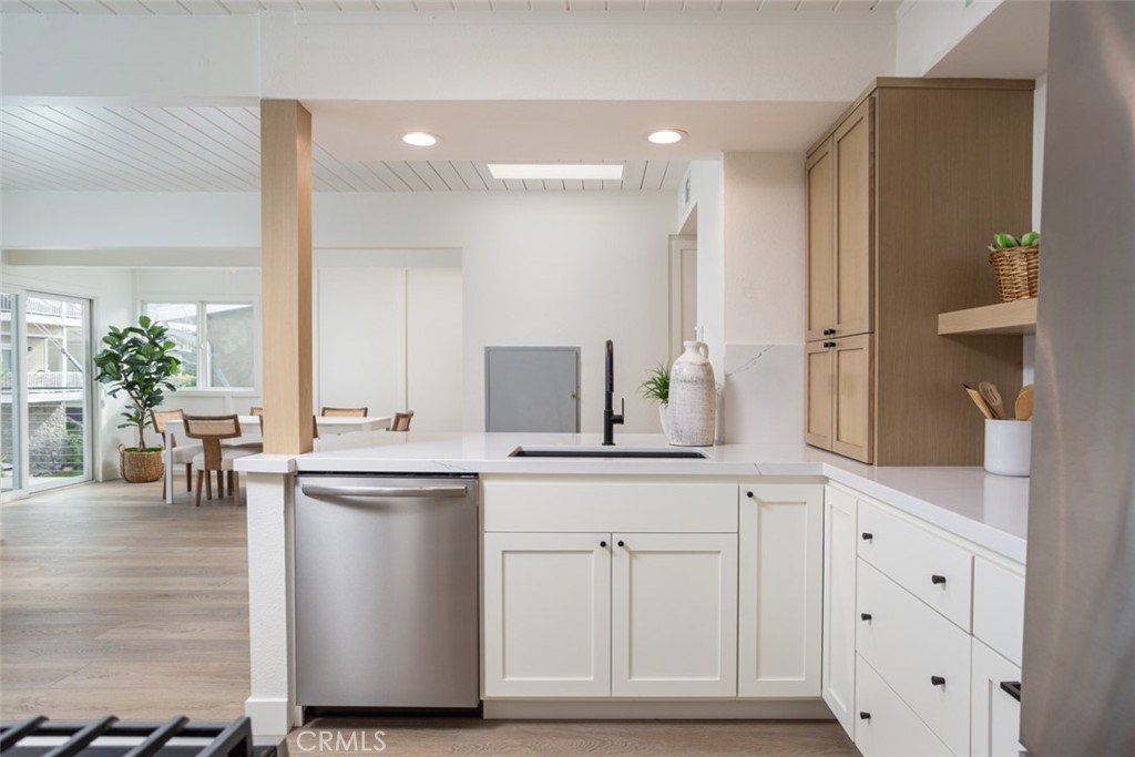 33961 Crystal Lantern Dana Point, CA 92629 - Photo 7 of 28 a kitchen with white cabinets and sink