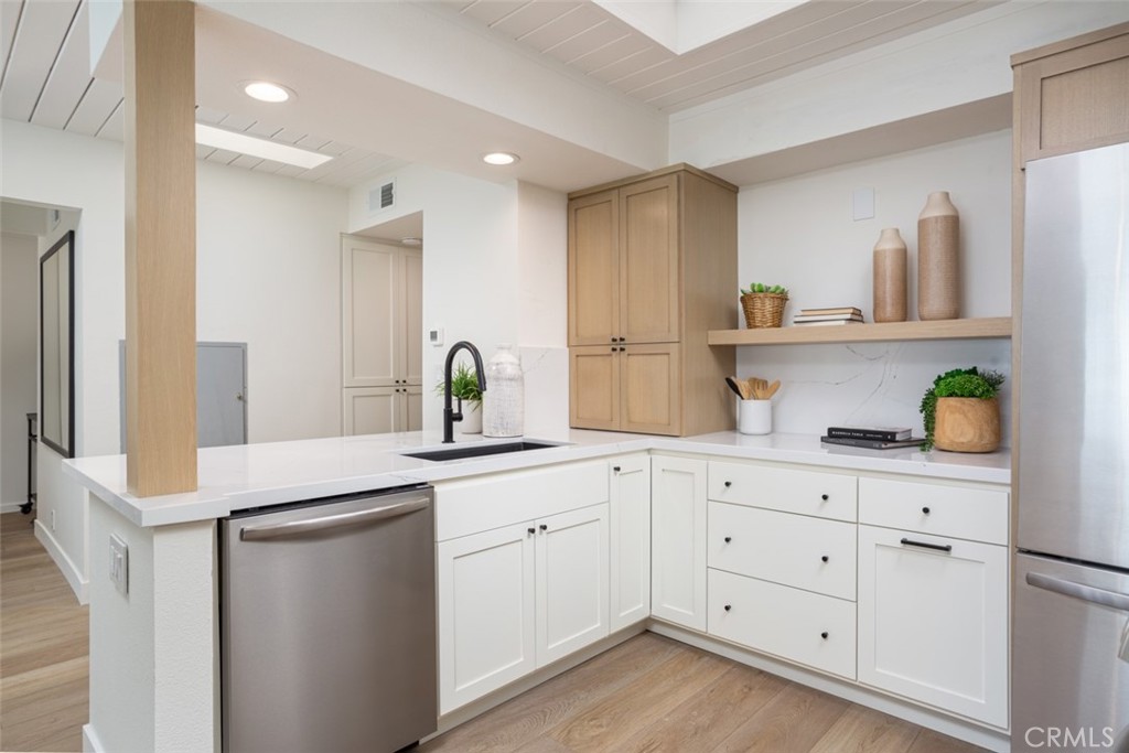 33961 Crystal Lantern Dana Point, CA 92629 - Photo 8 of 28 a kitchen with white cabinets white appliances and sink