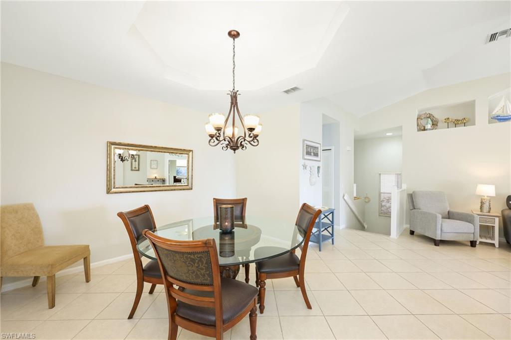 7828 Gardner Drive, Unit 5202 Naples, FL 34109 - Photo 13 of 44 a view of a dining room with furniture