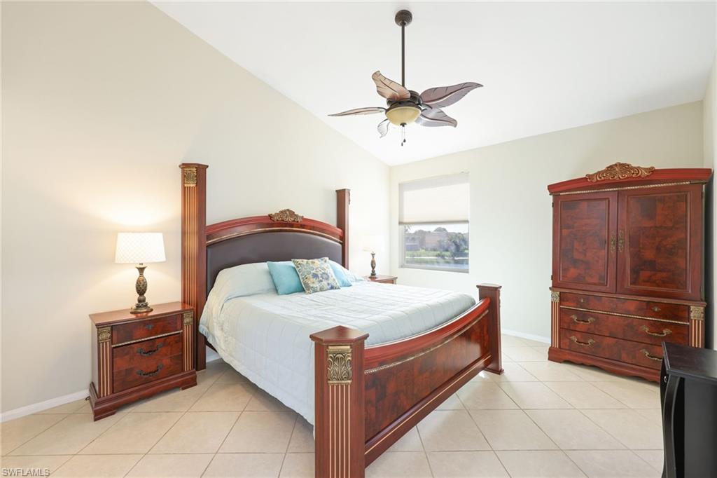 7828 Gardner Drive, Unit 5202 Naples, FL 34109 - Photo 15 of 44 a large bed sitting in a bedroom and table