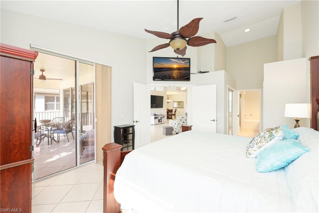 7828 Gardner Drive, Unit 5202 Naples, FL 34109 - Photo 17 of 44 a spacious bedroom with a large bed and a large window