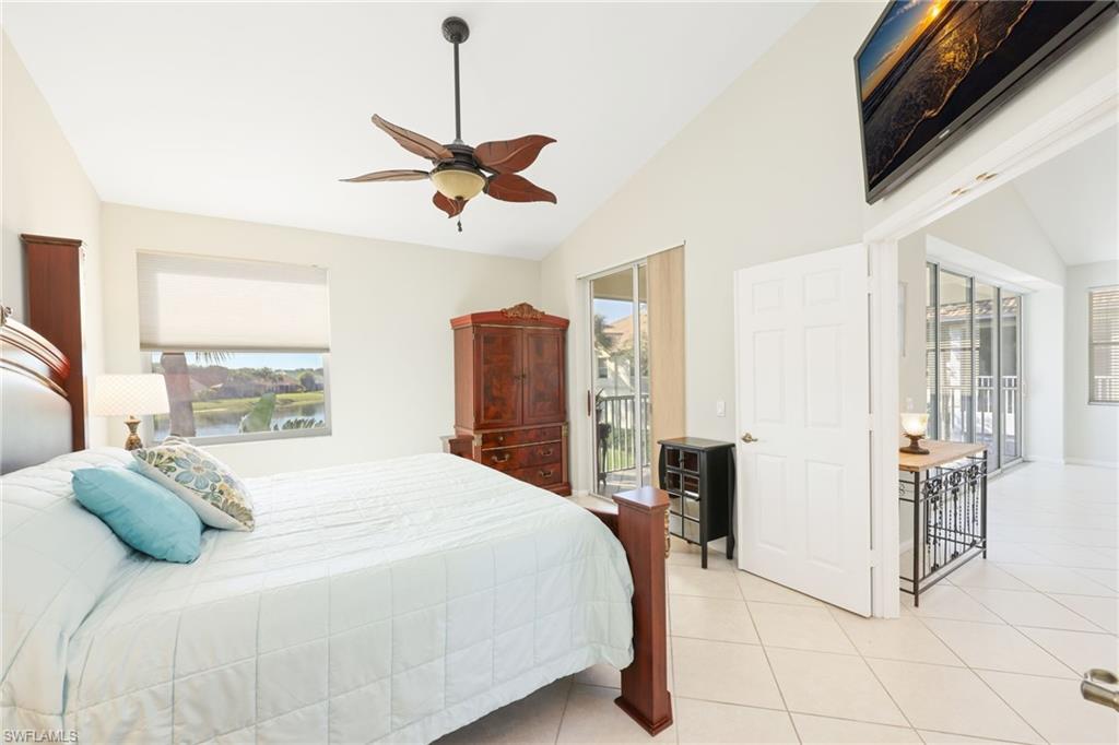 7828 Gardner Drive, Unit 5202 Naples, FL 34109 - Photo 18 of 44 a bedroom with a bed and ceiling fan