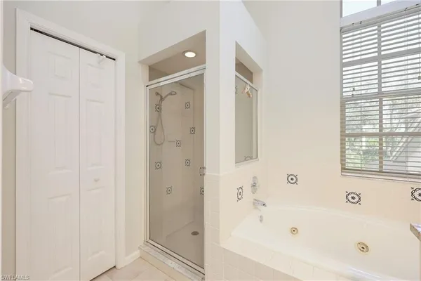 a bathroom with a bathtub shower and a sink