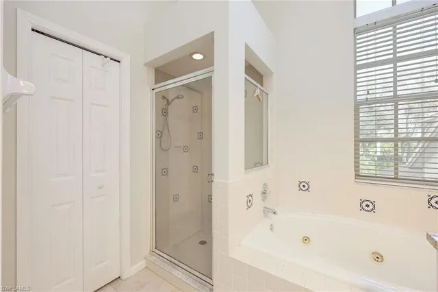 a bathroom with a bathtub shower and a sink