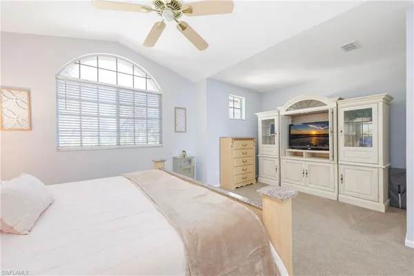 a spacious bedroom with a bed and a window