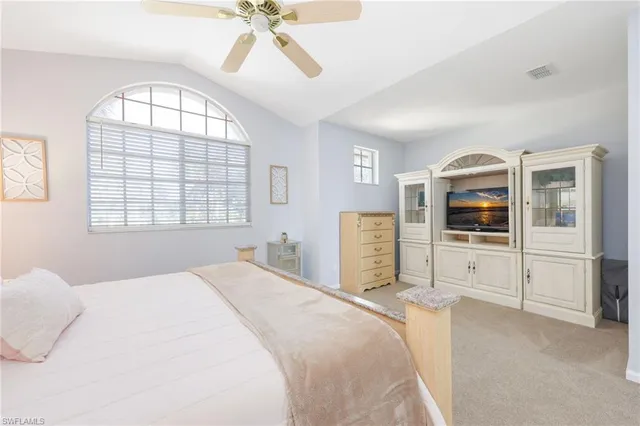 a spacious bedroom with a bed and a window