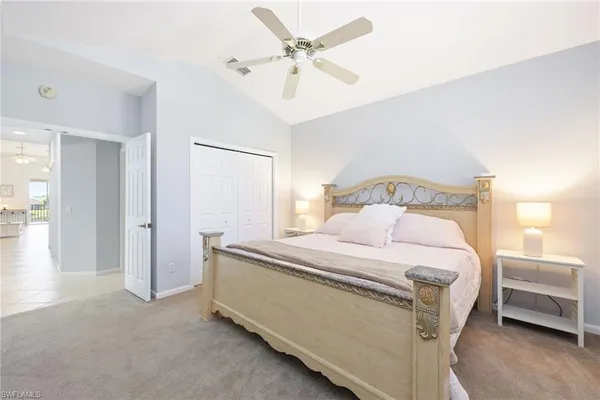 a bedroom with a bed and a ceiling fan