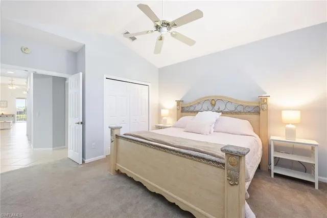 a bedroom with a bed and a ceiling fan