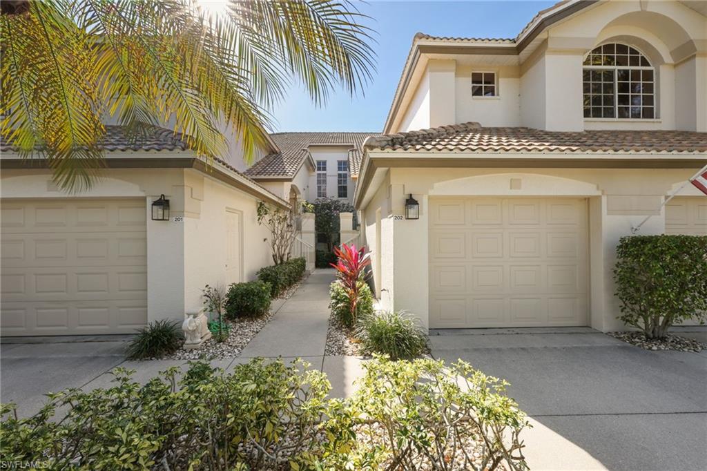 7828 Gardner Drive, Unit 5202 Naples, FL 34109 - Photo 32 of 44 a front view of a house with a yard