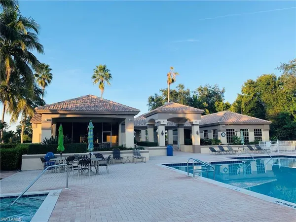 a view of a table and chairs under an umbrella