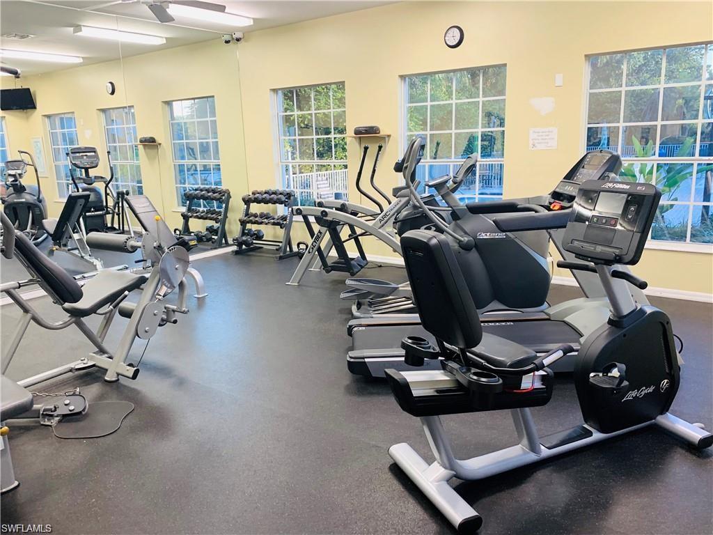7828 Gardner Drive, Unit 5202 Naples, FL 34109 - Photo 41 of 44 a room with gym equipment and a large window