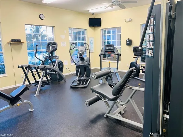 a kitchen with a sink and a stove with wooden floor