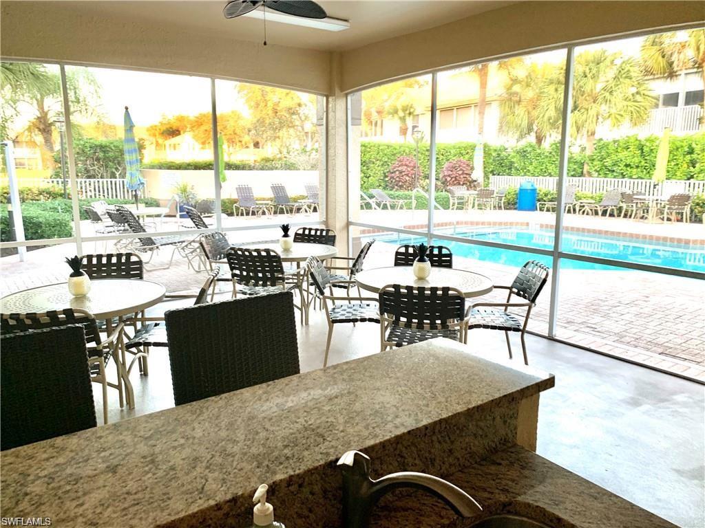 7828 Gardner Drive, Unit 5202 Naples, FL 34109 - Photo 43 of 44 a view of a dining room with furniture window and outside view