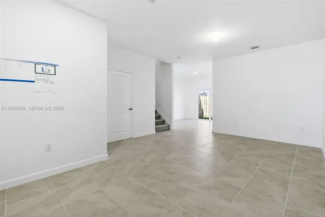 a view of an empty room with stairs