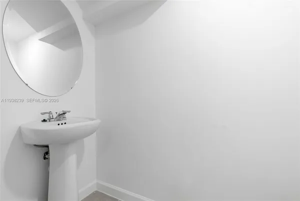 a white toilet sitting next to a white wall