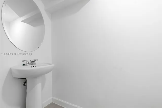 a white toilet sitting next to a white wall