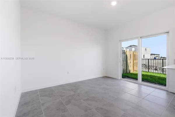 a view of a room with window and wooden floor