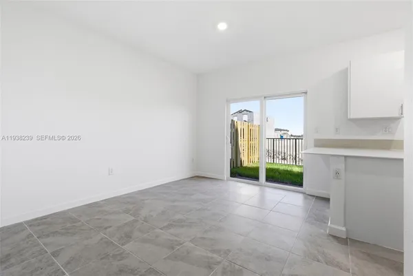 a view of kitchen with kitchen island and windows