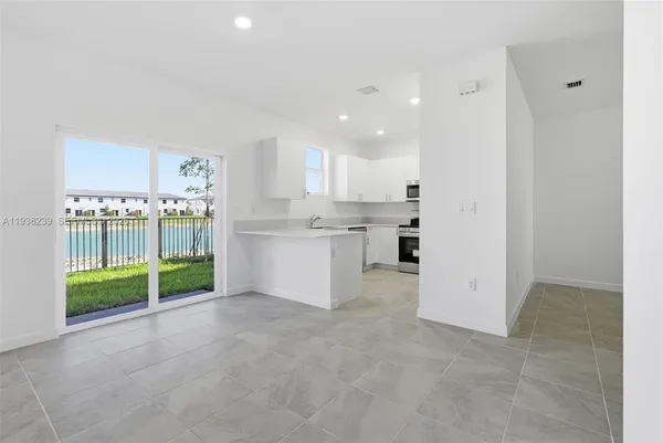 a view of kitchen with kitchen island and stainless steel appliances