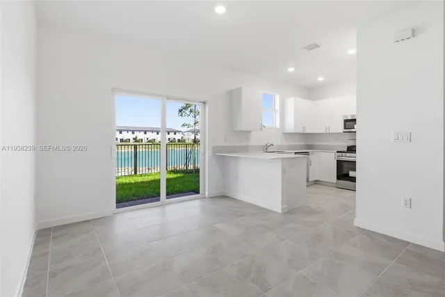 a view of kitchen with refrigerator stove microwave and stove