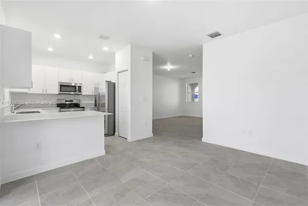 a kitchen with a sink a stove and refrigerator