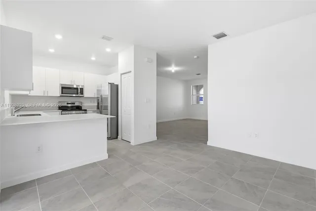 a kitchen with a sink a stove and refrigerator