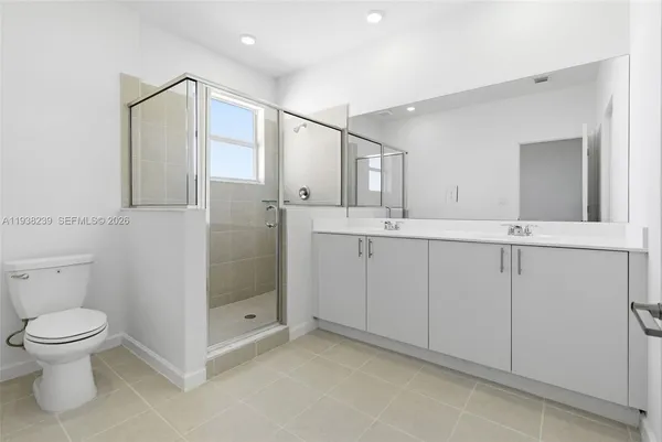 a bathroom with a double vanity sink and mirror