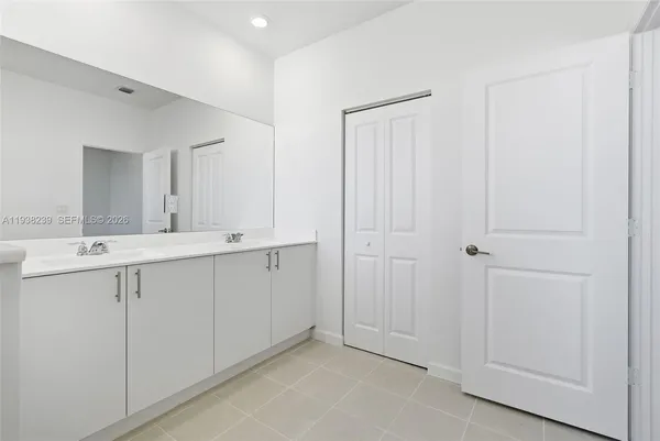 a spacious bathroom with a granite countertop sink a toilet and shower