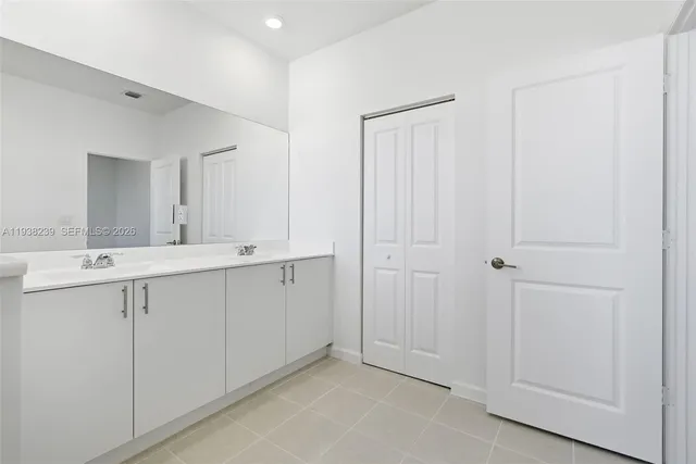 a spacious bathroom with a granite countertop sink a toilet and shower