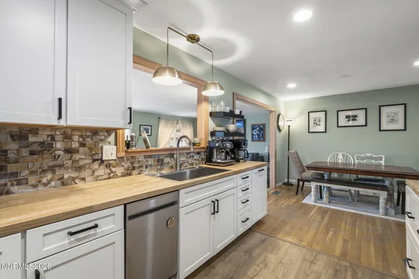 a kitchen with stainless steel appliances kitchen island granite countertop a sink and cabinets
