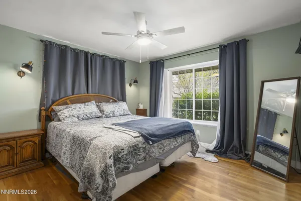a bedroom with a bed and a mirror