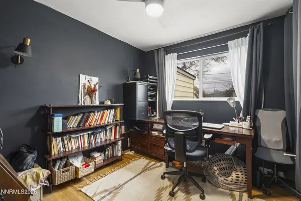 a work room with furniture and a book shelf