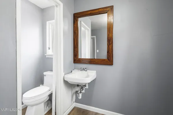 a bathroom with a sink toilet and mirror