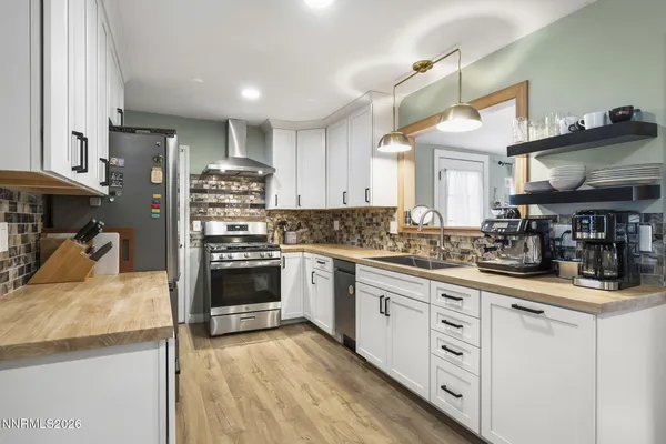 a kitchen with granite countertop a stove and cabinets