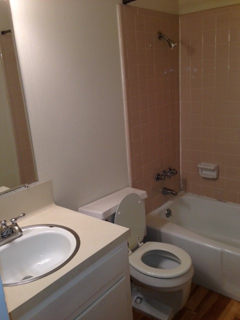 5001 Bull Creek Road, Unit 117 Austin, TX 78731 - Photo 7 of 10 Full bath featuring vanity, bathing tub / shower combination, and wood finished floors