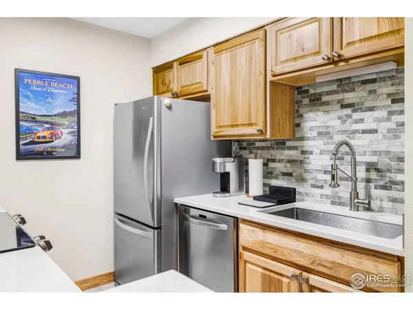 a kitchen with stainless steel appliances granite countertop a refrigerator a stove and a sink