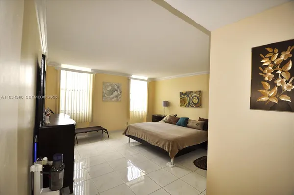 a bedroom with a bed and a painting on the wall