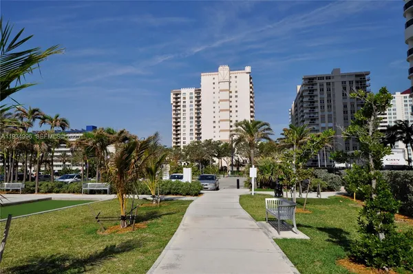 a front view of a multi story building with yard
